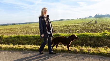 donna sorridente cammina con il cane